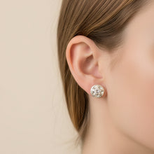 Charger l'image dans la galerie, A single round stud earring with a white and black marbled pattern, shown next to its silver butterfly back on a textured blue background.